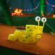 SpongeBob takes the form of a snail and slithers his way down an incline.